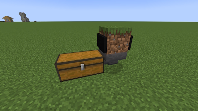 Minecart dentro de un bloque de hierba con una tolva debajo mirando hacia un cofre