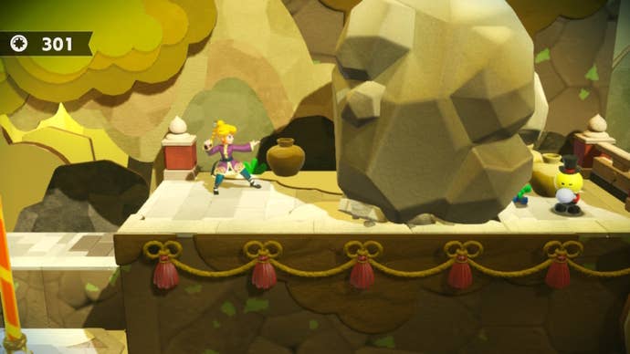 Kung Fu Peach se tient à côté d'un rocher avec un Theet coincé derrière lui dans Princess Peach : Showtime